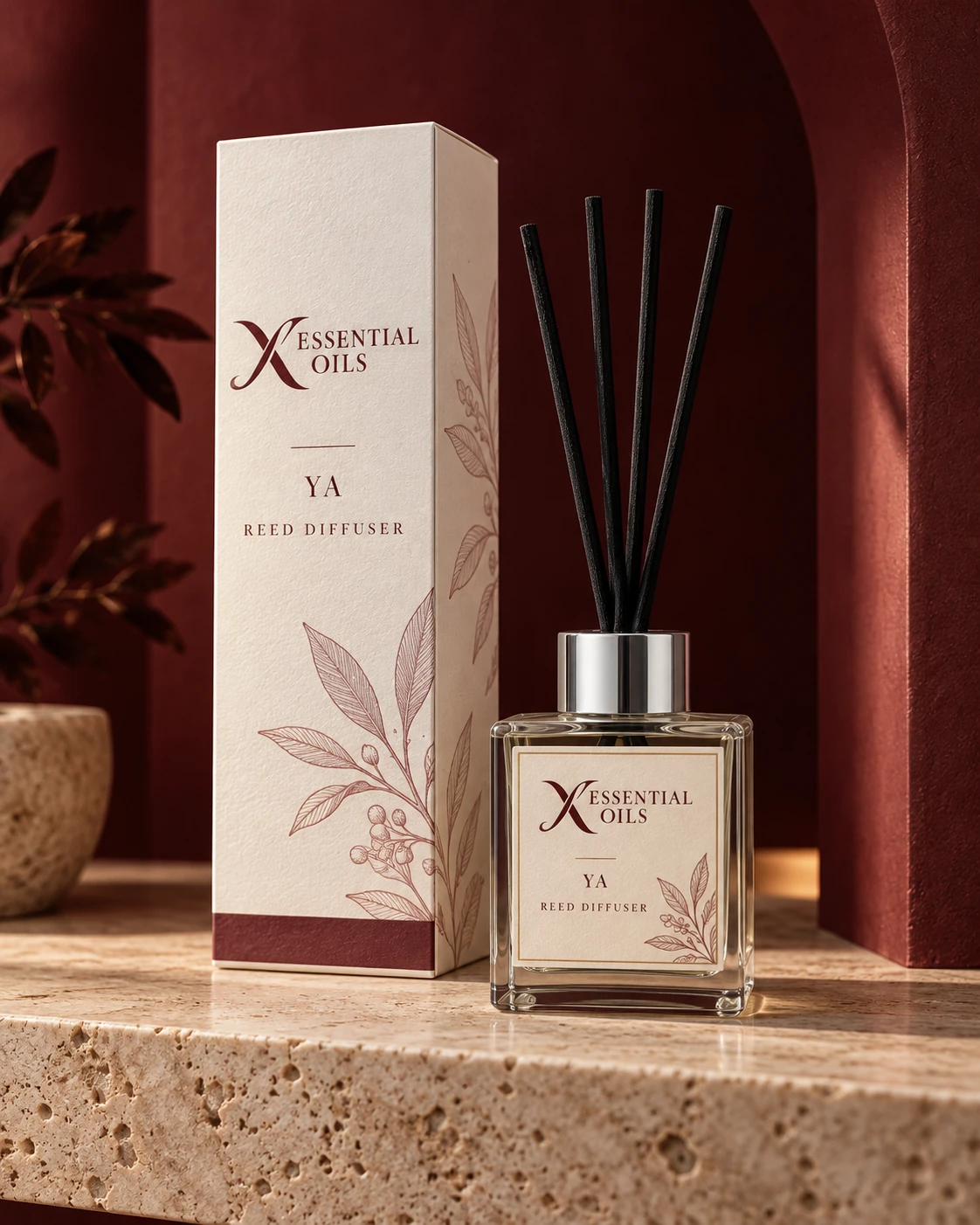 Ya reed diffuser with X Essential Oils branding in a carefully styled setting.