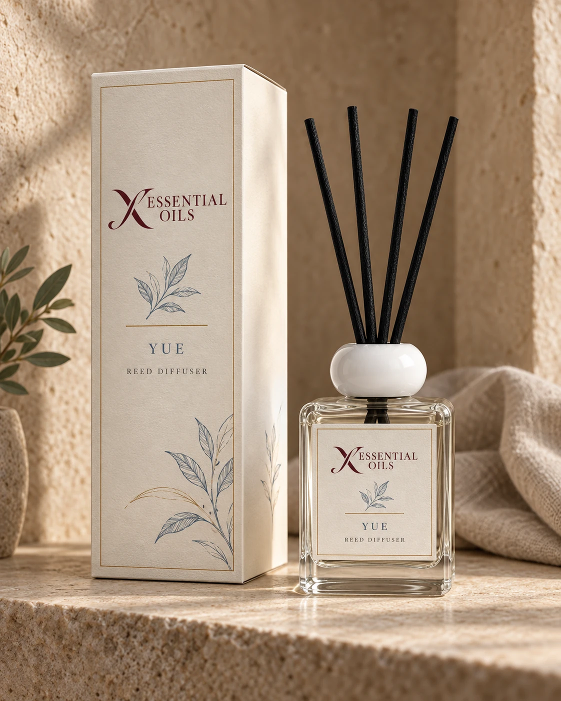 Yue reed diffuser with X Essential Oils branding in a carefully styled setting.