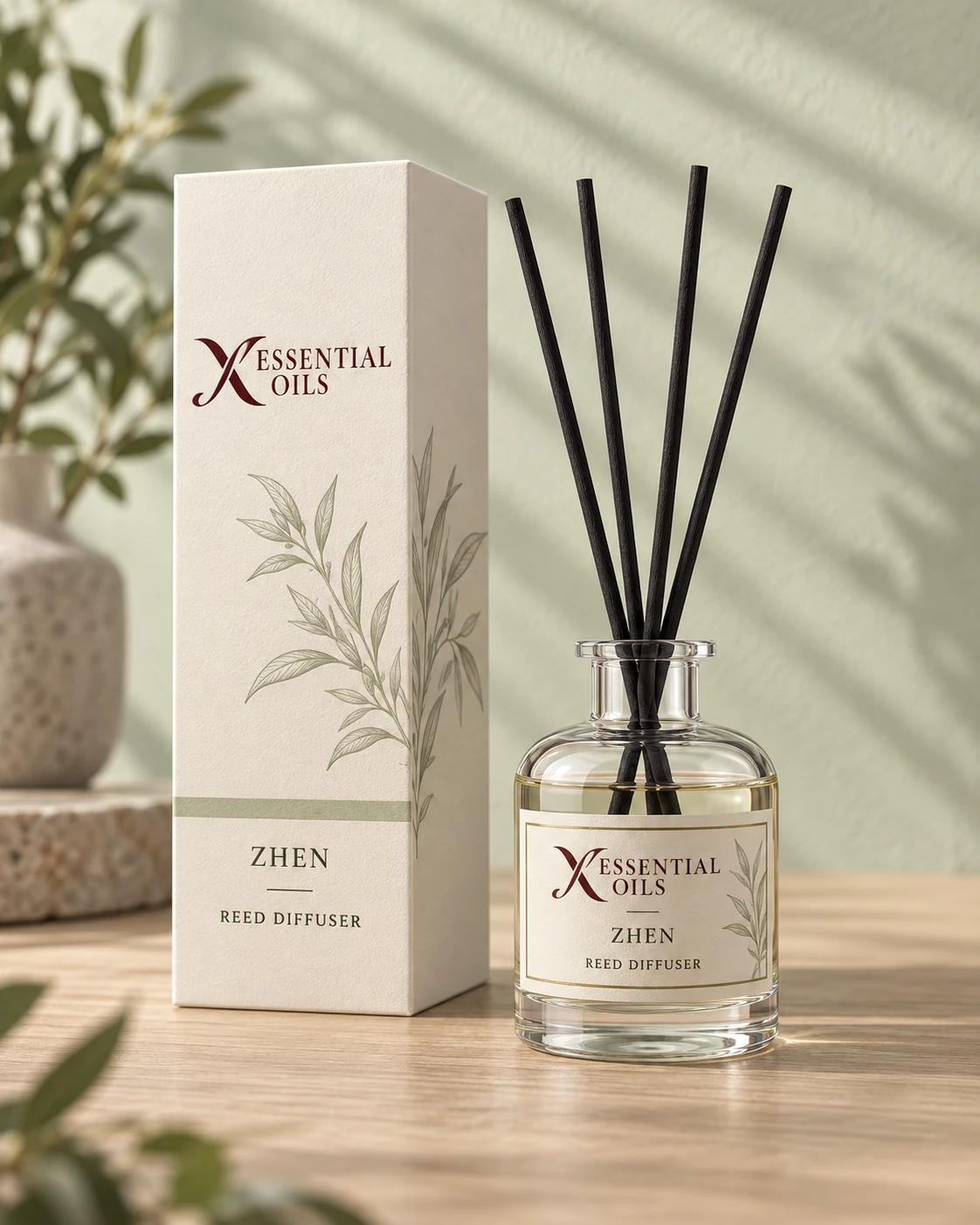 Zhen reed diffuser with X Essential Oils branding in a carefully styled setting.