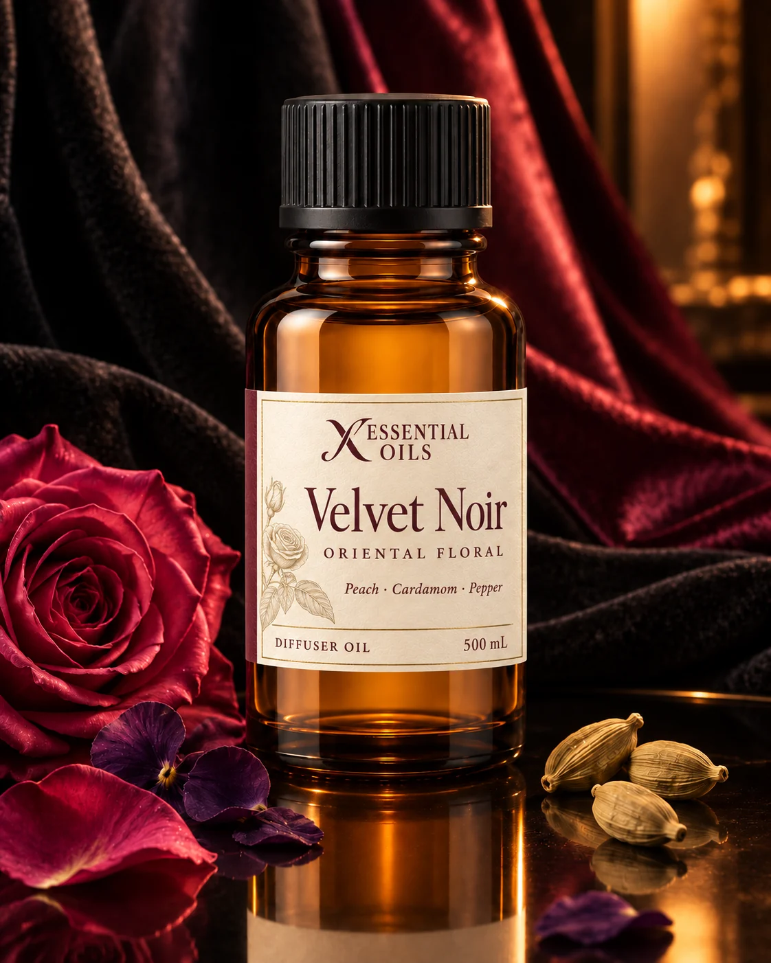 Standard glass oil bottle on smoked mirror amid black velvet, garnet silk, rose petals and warm amber light.